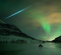 A Geminid meteor streaks through the Northern Lights